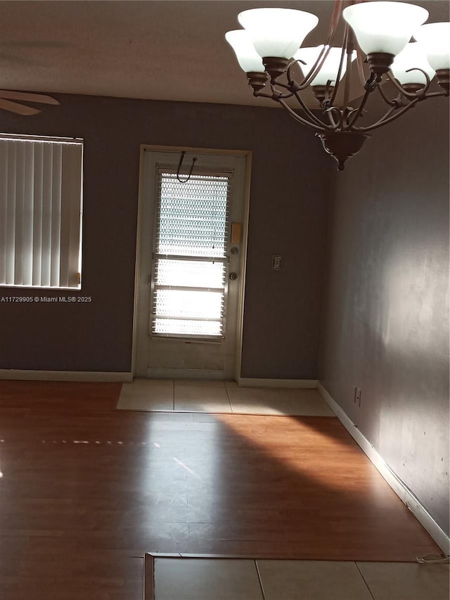 interior space featuring a notable chandelier and tile patterned flooring