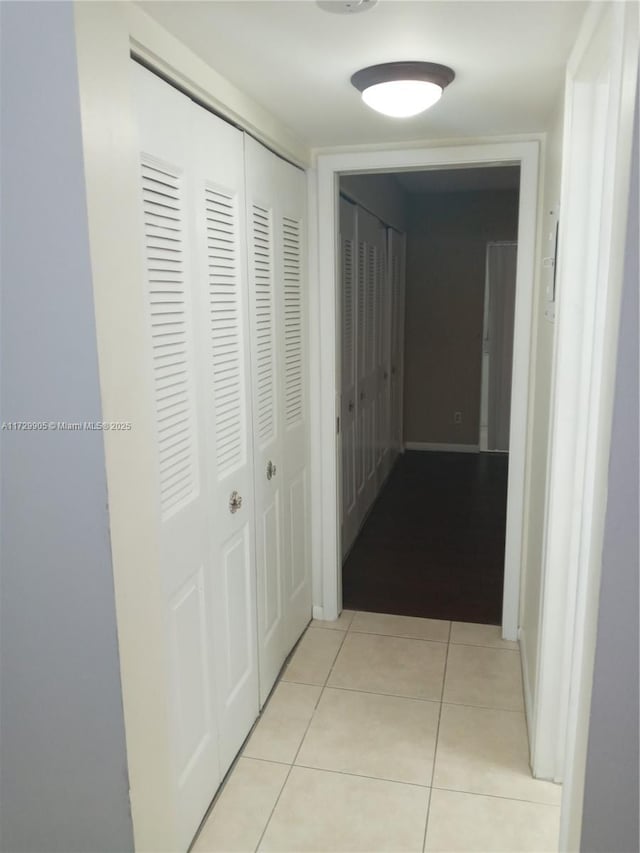 corridor featuring light tile patterned floors