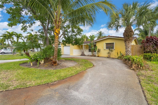 view of front of house with a front yard and a garage