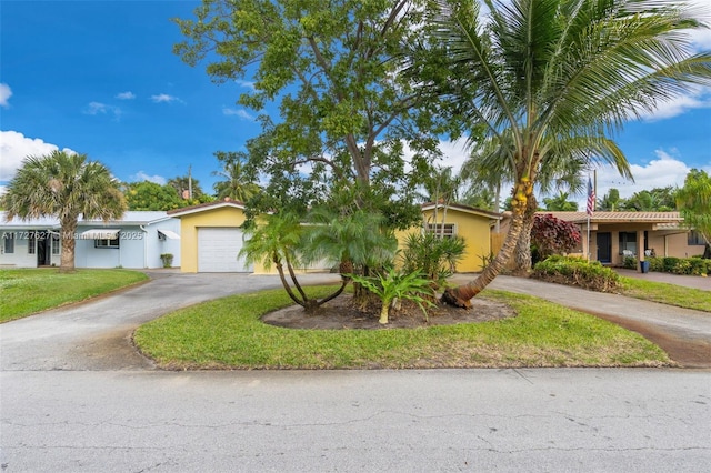 view of front of property with a garage and a front lawn