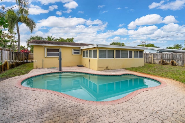 view of swimming pool with a patio area and a lawn