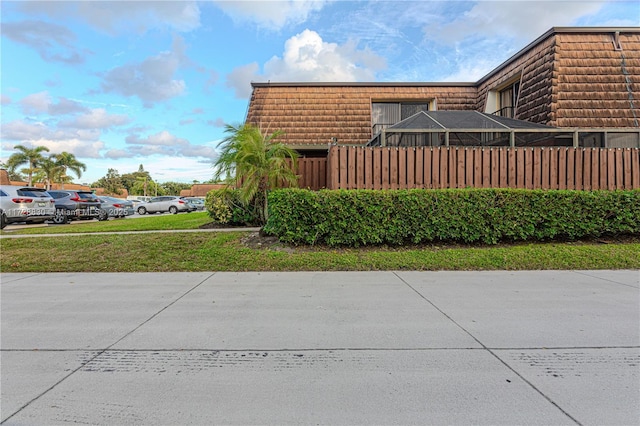 view of side of home with glass enclosure