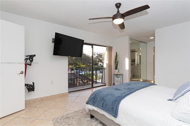 tiled bedroom with a textured ceiling, access to exterior, ceiling fan, and ensuite bathroom