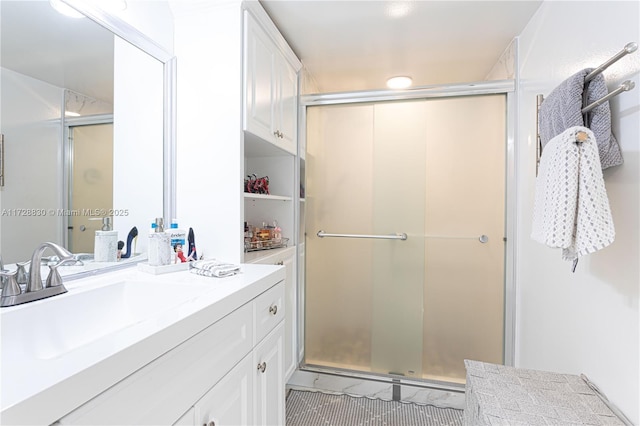 bathroom with walk in shower and vanity