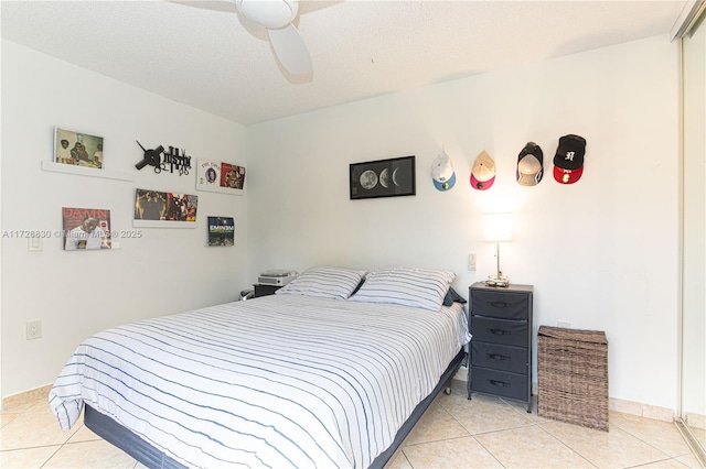 tiled bedroom featuring ceiling fan