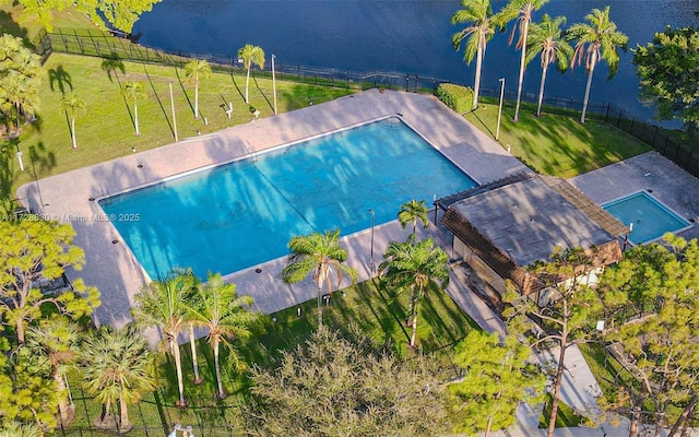 view of swimming pool featuring a water view