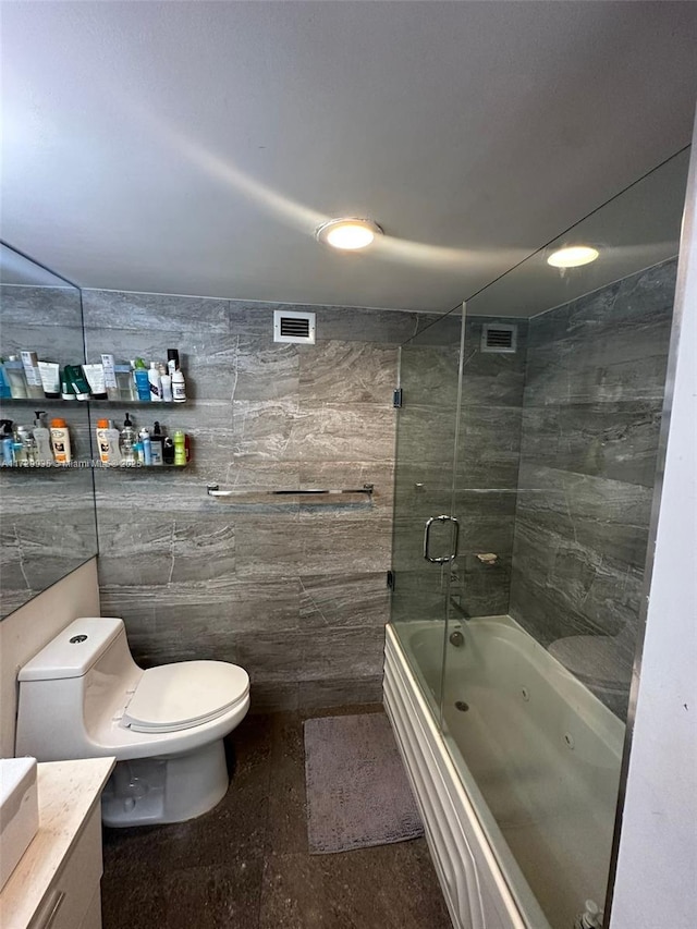 full bathroom featuring vanity, toilet, shower / bath combination, and tile walls