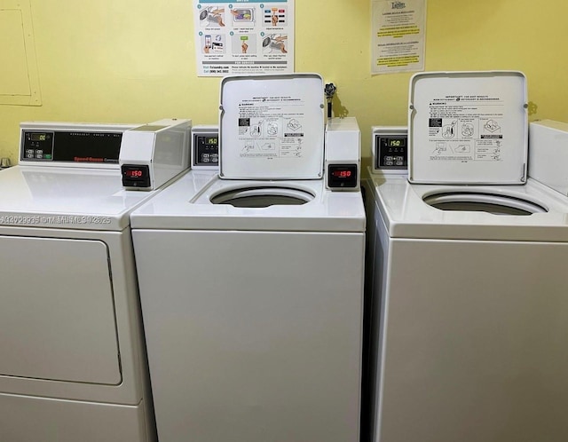 clothes washing area featuring washer and clothes dryer and electric panel