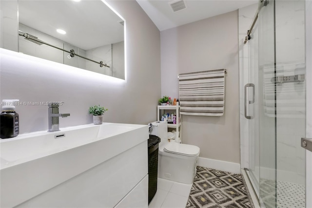 bathroom with a shower with door, tile patterned floors, toilet, and vanity