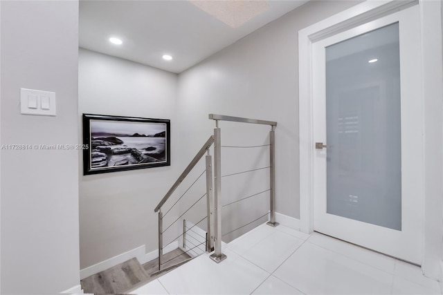 stairway featuring tile patterned floors