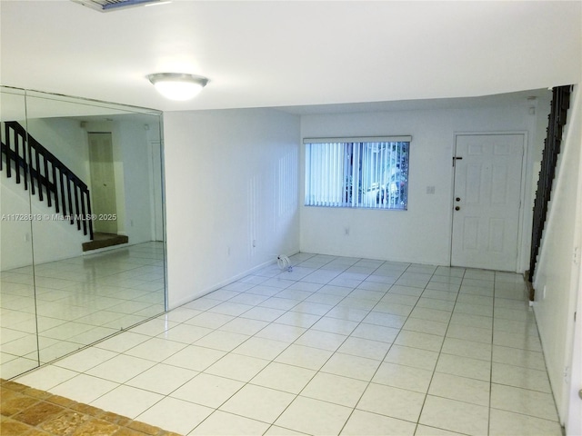 spare room featuring light tile patterned floors