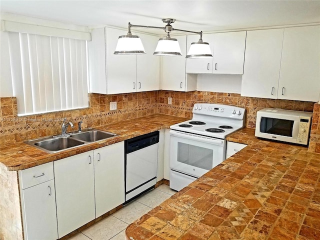 kitchen featuring pendant lighting, sink, white appliances, and white cabinets