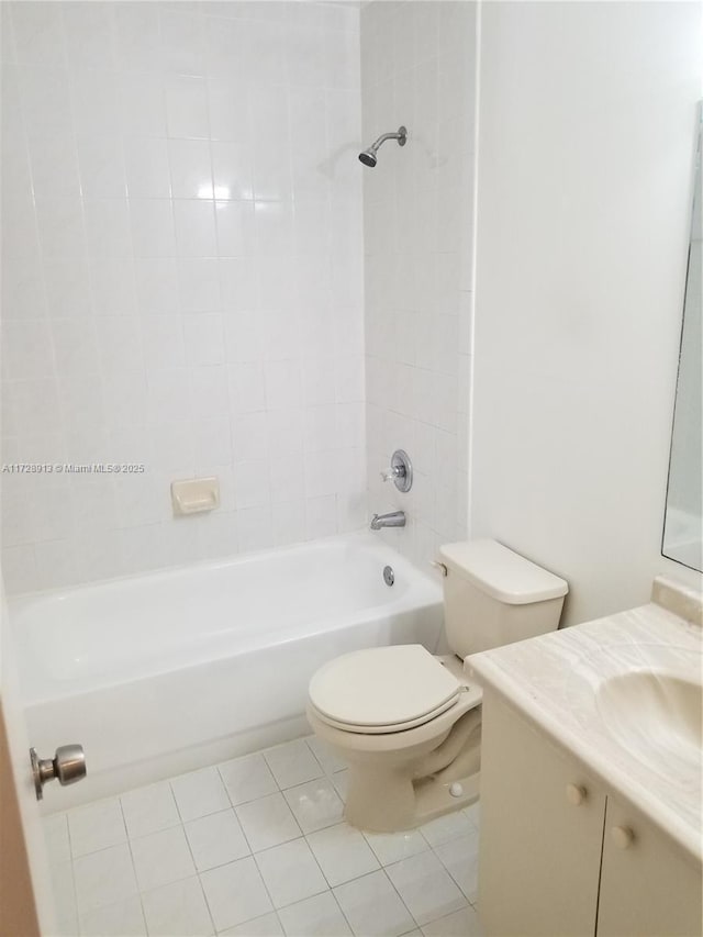 full bathroom featuring vanity, tiled shower / bath, tile patterned floors, and toilet