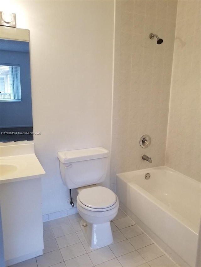 full bathroom with tile patterned flooring, vanity, tiled shower / bath combo, and toilet