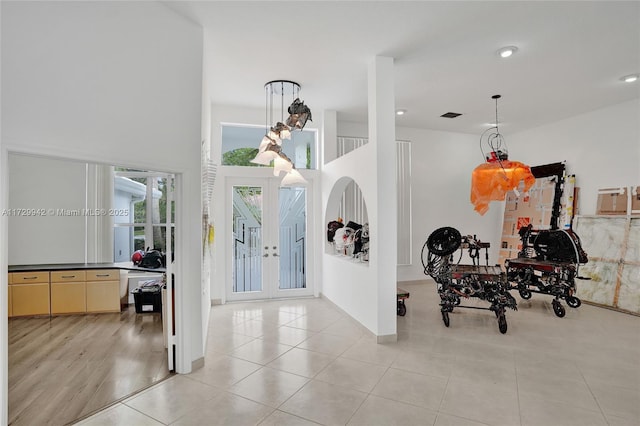 tiled foyer entrance featuring french doors