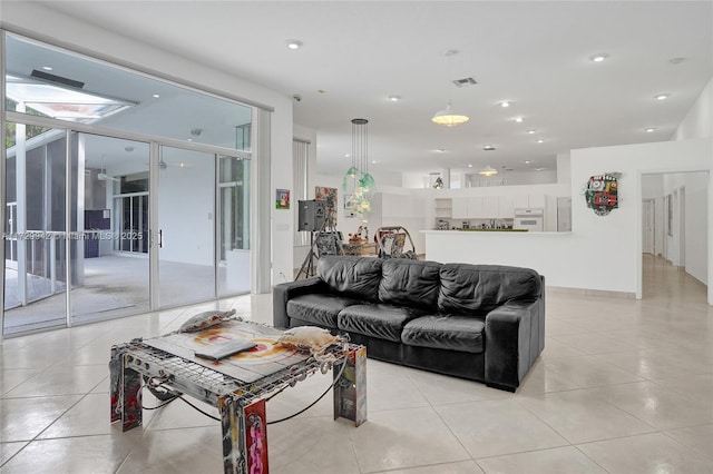 living room featuring floor to ceiling windows and light tile patterned floors