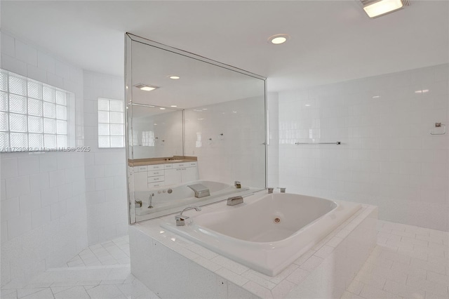 bathroom featuring plus walk in shower, tile patterned flooring, and tile walls