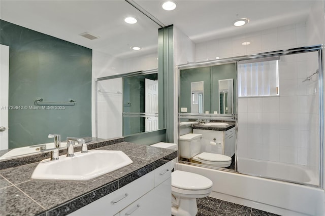 full bathroom with toilet, tile patterned floors, enclosed tub / shower combo, and vanity