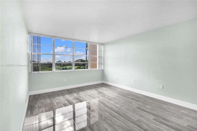 spare room with hardwood / wood-style flooring