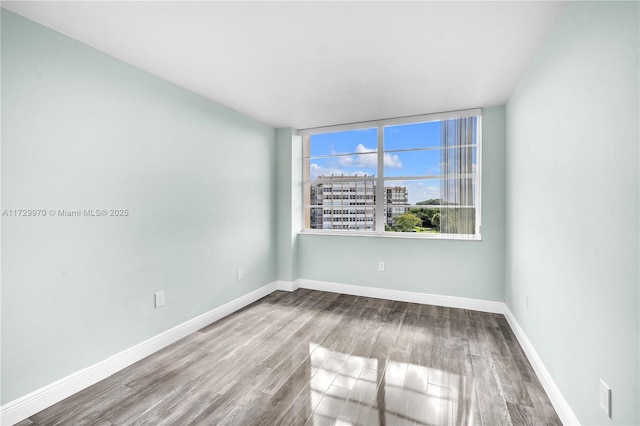 unfurnished room featuring hardwood / wood-style floors