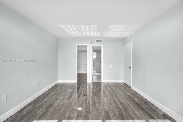 spare room featuring dark hardwood / wood-style flooring