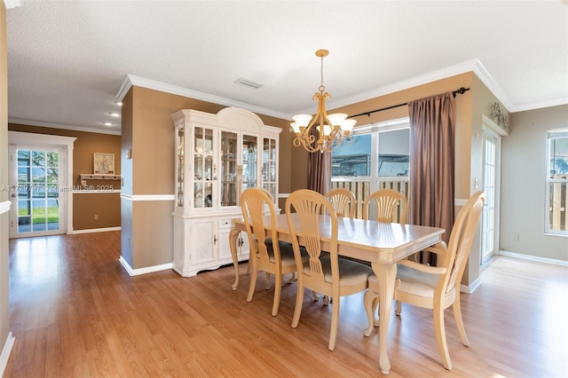 dining room with light wood-type flooring, baseboards, visible vents, and a chandelier