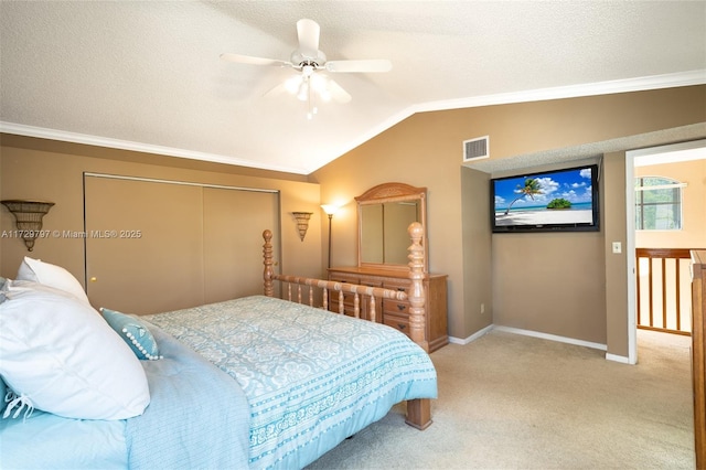 bedroom with a textured ceiling, visible vents, vaulted ceiling, and carpet flooring