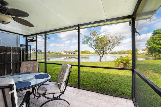 sunroom with a water view and a ceiling fan