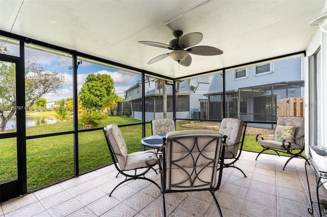 sunroom with ceiling fan and a residential view