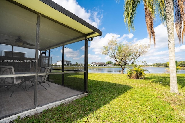 view of yard featuring a water view and a patio area