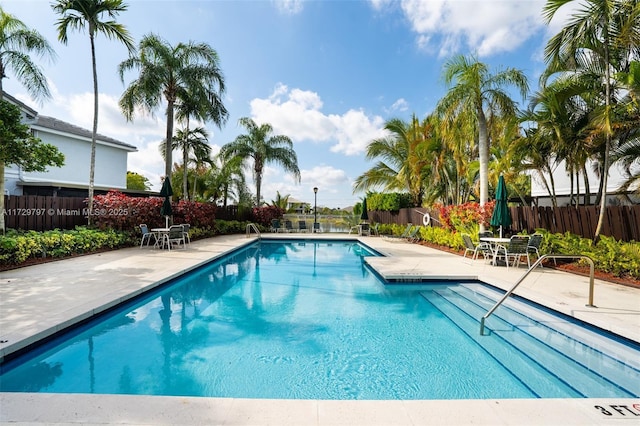 pool featuring a patio and fence