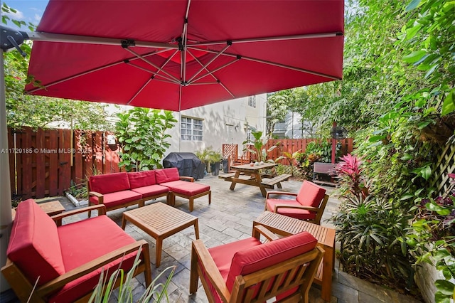 view of patio with outdoor lounge area and grilling area