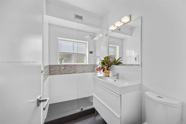 bathroom with vanity, toilet, and walk in shower