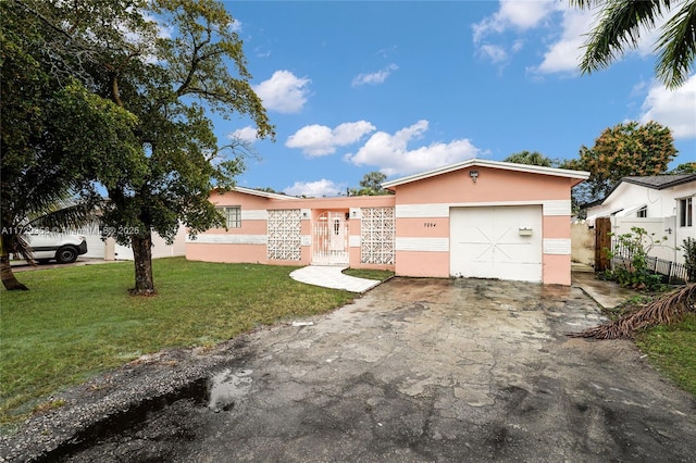 single story home with a garage and a front yard