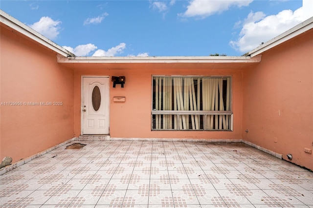 doorway to property with a patio