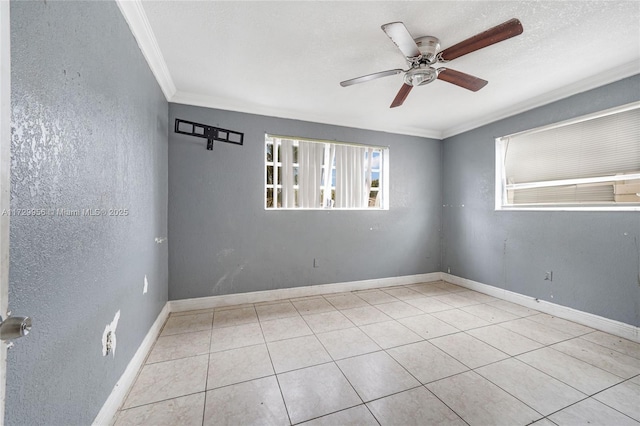 tiled empty room featuring ceiling fan, ornamental molding, and a textured ceiling