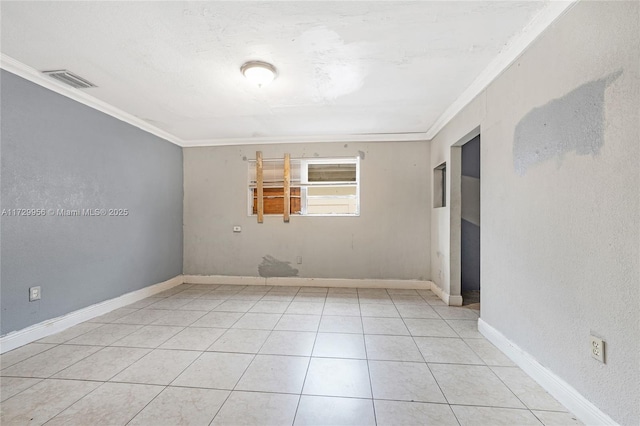 spare room with crown molding, light tile patterned floors, and a textured ceiling