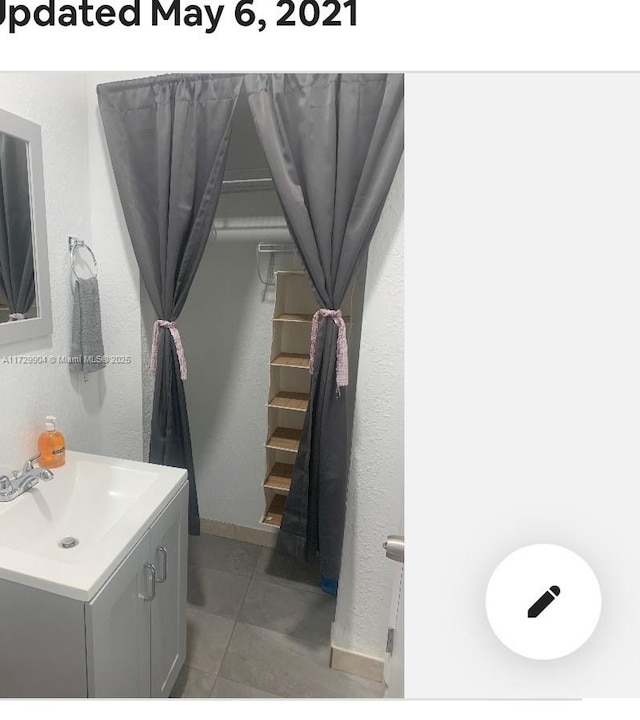 bathroom with vanity and tile patterned flooring