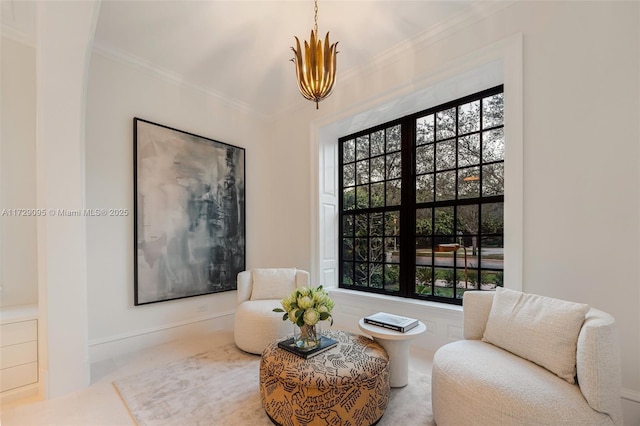 living area with a wealth of natural light and ornamental molding