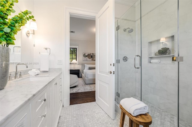 bathroom featuring a shower with door, ornamental molding, and vanity