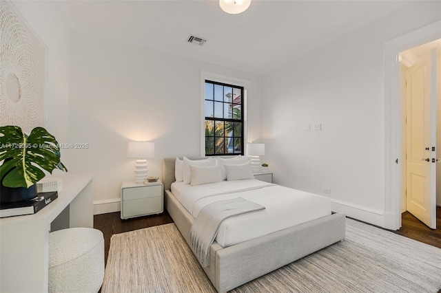 bedroom with crown molding and wood-type flooring