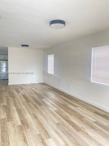 unfurnished room with light wood-type flooring