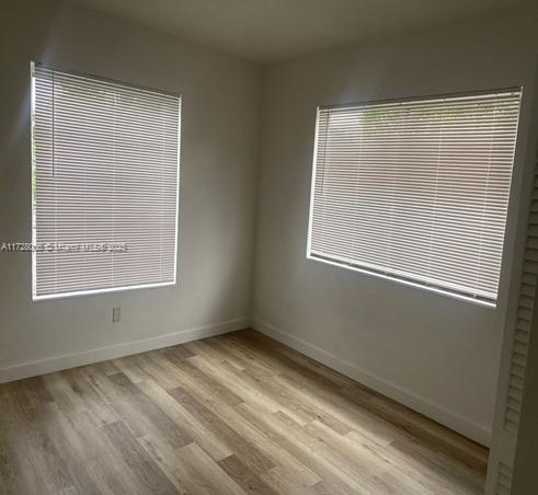 unfurnished room with light hardwood / wood-style floors