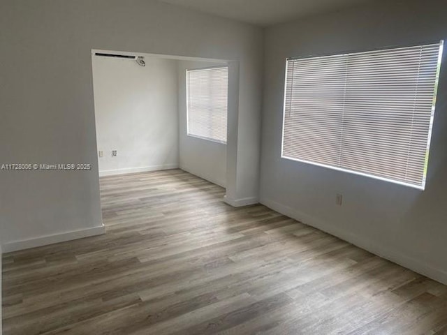 unfurnished room with light hardwood / wood-style flooring