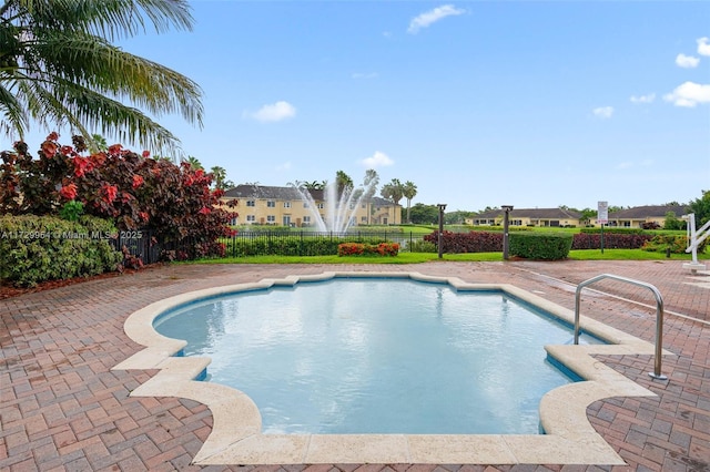 view of swimming pool with a patio area, a fenced in pool, and fence