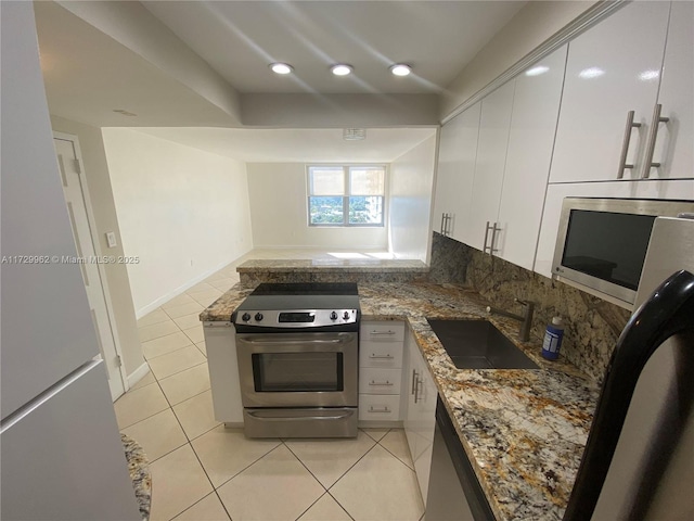 kitchen with sink, white cabinets, and stainless steel appliances