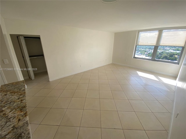 empty room with light tile patterned floors