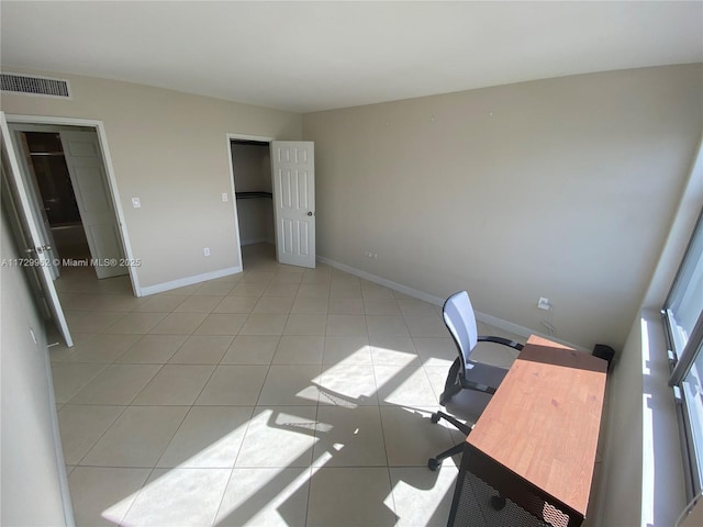 unfurnished office with light tile patterned floors