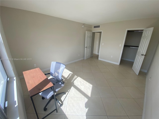 unfurnished office with light tile patterned floors