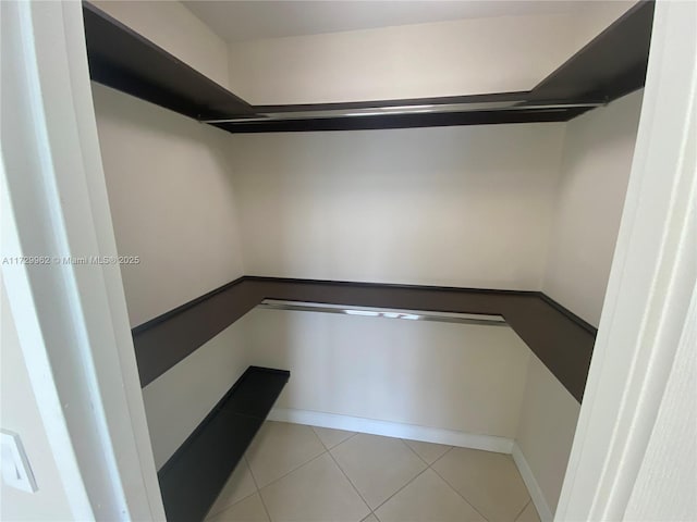 spacious closet featuring light tile patterned flooring